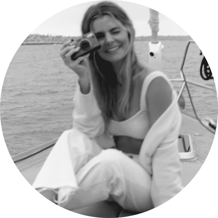 Valorie Darling on a boat holding a camera near her eye